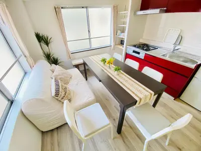 a living room with a couch and a table at Tomo House Oshiage - from 2 minutes station \u62bc\u4e0a \u99c5\u304b\u3089\u5f92\u6b692\u5206 in Tokyo