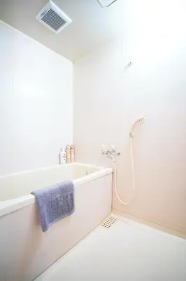 a white bathroom with a tub and a shower at Tomo House \u897f\u65b0\u5bbf\u4e94\u4e01\u76ee\u30a2\u30d1\u30fc\u30c8 303 in Tokyo