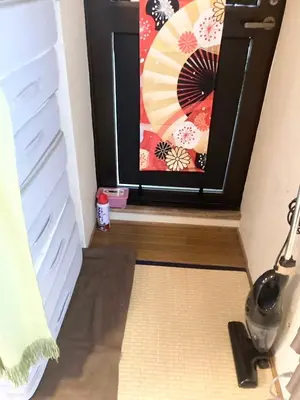 a corner of a room with a picture on the wall at Tomo House \u897f\u65b0\u5bbf\u4e94\u4e01\u76ee\u30a2\u30d1\u30fc\u30c8 303 in Tokyo