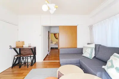 a living room with a couch and a table at Tomo House Yoyogi 301 - from 4 minutes station \u4ee3\u3005\u6728 301 \u99c5\u304b\u3089\u5f92\u6b694\u5206 in Tokyo