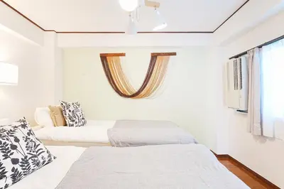 a bedroom with two beds and a window at Tomo House Yoyogi 301 - from 4 minutes station \u4ee3\u3005\u6728 301 \u99c5\u304b\u3089\u5f92\u6b694\u5206 in Tokyo