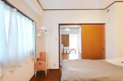 a bedroom with a bed and a large window at Tomo House Yoyogi 301 - from 4 minutes station \u4ee3\u3005\u6728 301 \u99c5\u304b\u3089\u5f92\u6b694\u5206 in Tokyo