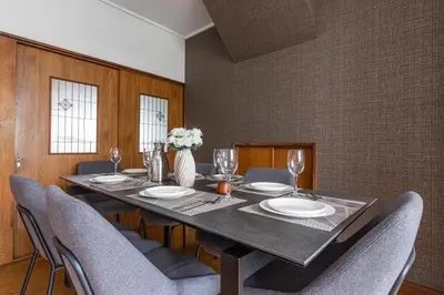 a dining room with a table and chairs at Hanna Inn Zoshigaya in Tokyo