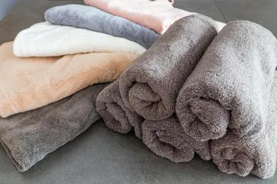 a pile of towels sitting on the floor at Hanna Inn Zoshigaya in Tokyo