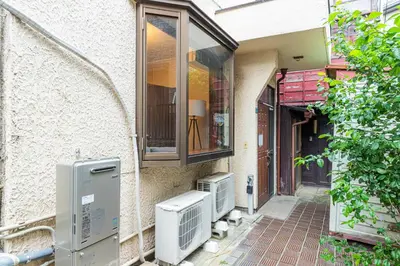 a building with a window and an air conditioner at Hanna Inn Zoshigaya in Tokyo
