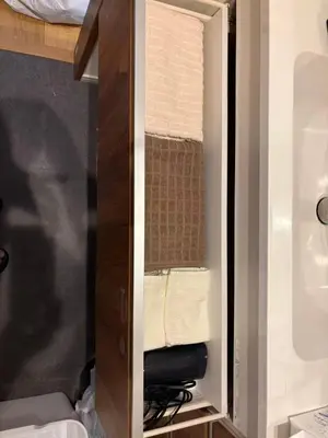 a closet with a wooden cabinet with a towel at \u9759\u8c27\u65f6\u5149 1f in Tokyo