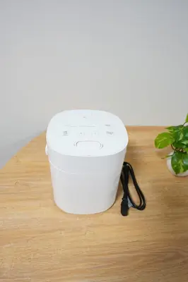 a white bucket sitting on a wooden table at Aki Hiroo Stay 101 in Tokyo