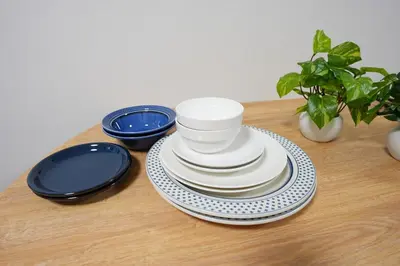 a pile of plates and bowls sitting on a table at Aki Hiroo Stay 101 in Tokyo