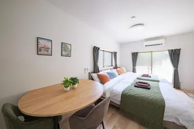 a bedroom with a bed and a table and chairs at Aki Hiroo Stay 101 in Tokyo