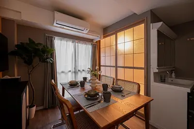 a dining room table with chairs and a kitchen at Ikebukuro Stay,Higashiikebukuro walk 4 min equipped with an elevator in Tokyo