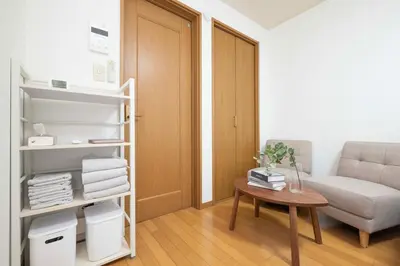 a living room with a couch and a table at Aki Shin-Okubo Stay 105 in Tokyo