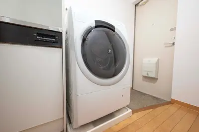 a washer and dryer in a room with a door at Aki Shin-Okubo Stay 105 in Tokyo