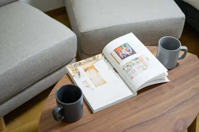 a coffee table with a book and two mugs at Aki Shin-Okubo Stay 105 in Tokyo