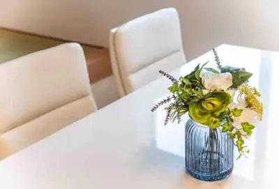 a vase of flowers on a table with two chairs at lkebukuro-Five palace in Tokyo