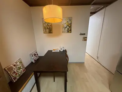 a dining room with a table and chairs and a light at \u79cb\u53f6\u539f\u6c11\u5bbf\u6210\u7530\u7fbd\u7530\u673a\u573a\u53ef\u4ee5\u76f4\u8fbe\u6b65\u884c10\u5206\u949f\u62b5\u8fbe\u8f66\u7ad9\u4ea4\u901a\u4fbf\u5229\u5b89\u9759\u53ef\u5165\u4f4f10\u4eba in Tokyo