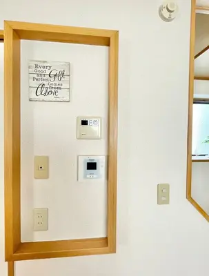 a mirror on a wall with a sign on it at Shinkoiwa Matsushima HOUSE in Tokyo
