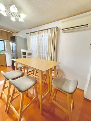 a dining room table and chairs in a room at Shinkoiwa Matsushima HOUSE in Tokyo