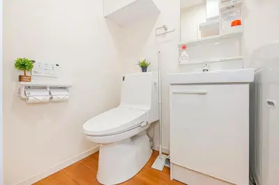 a white bathroom with a toilet and a sink at Akihabara Skytree Premium Apartment 201 in Tokyo