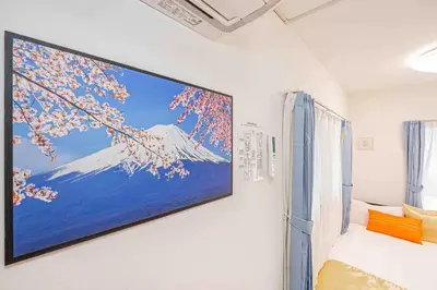 a tv hanging on a wall in a room at Akihabara Skytree Premium Apartment 201 in Tokyo