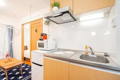 a small kitchen with a sink and a microwave at Akihabara Skytree Premium Apartment 301 in Tokyo