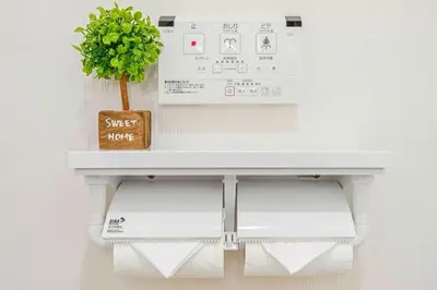 a white table with a plant on top of it at Akihabara Skytree Premium Apartment 301 in Tokyo