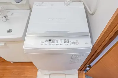 a white washing machine sitting in a room at Akihabara Skytree Premium Apartment 301 in Tokyo