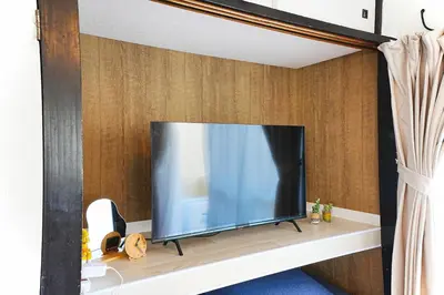a flat screen tv sitting on a shelf at Tomo House Yoyogi 302 - from 4 minutes station \u4ee3\u3005\u6728 302 \u99c5\u304b\u3089\u5f92\u6b694\u5206 in Tokyo