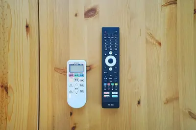 a remote control and an ipod sitting on a table at Tomo House Yoyogi 302 - from 4 minutes station \u4ee3\u3005\u6728 302 \u99c5\u304b\u3089\u5f92\u6b694\u5206 in Tokyo