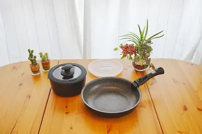 a frying pan on a wooden table with plants at Tomo House Yoyogi 302 - from 4 minutes station \u4ee3\u3005\u6728 302 \u99c5\u304b\u3089\u5f92\u6b694\u5206 in Tokyo