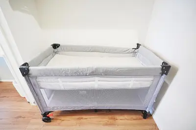 a bed frame in a room next to a wall at Tomo House Nishi-Shinjuku-Gochome - from 3 minutes station \u897f\u65b0\u5bbf\u6238\u5efa\u3066 \u99c5\u304b\u3089\u5f92\u6b693\u5206 in Tokyo