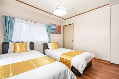 a room with two beds and a window at Ikebukuro and Yunxuan in Tokyo