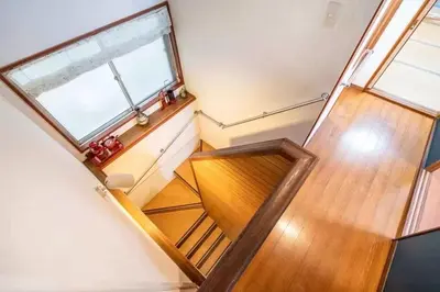 an overhead view of a wooden staircase with a window at Ikebukuro and Yunxuan in Tokyo