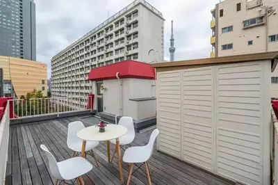 a patio with a table and chairs on a balcony at Ikebukuro and Yunxuan in Tokyo