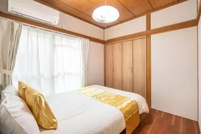 a bedroom with a bed and a window at Ikebukuro and Yunxuan in Tokyo