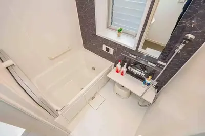 a white bathroom with a tub and a sink at Ikebukuro and Yunxuan in Tokyo