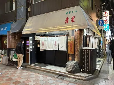 a man standing in front of a store on a street at NakanoRetreat in Tokyo