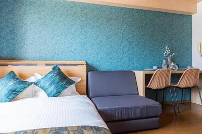 a bedroom with a bed and a chair at NakanoRetreat in Tokyo