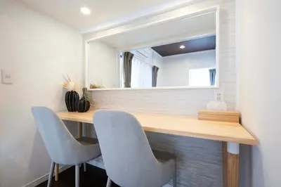 a room with a desk with two chairs and a mirror at \u672a\u516c\u958bB107 sumicco in Tokyo