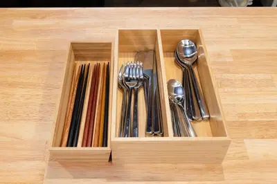 a wooden box with silver utensils in it at \u672a\u516c\u958bB107 sumicco in Tokyo