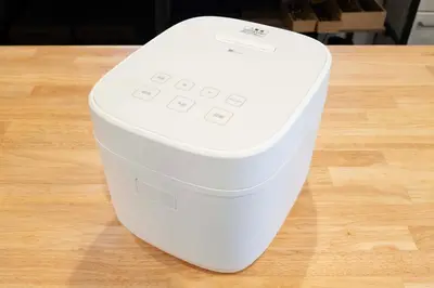 a white cooler sitting on top of a wooden table at \u672a\u516c\u958bB107 sumicco in Tokyo