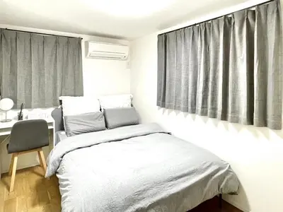 a bedroom with a bed and a desk and window at Detached Villa 4LDK Free Parking, 4 min walk to Sengawa Station, Toshima Ward in Tokyo