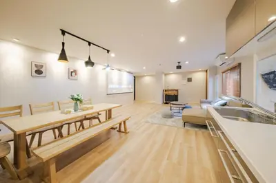 a kitchen and living room with a table and a couch at Breeze Stay Shiohama in Tokyo