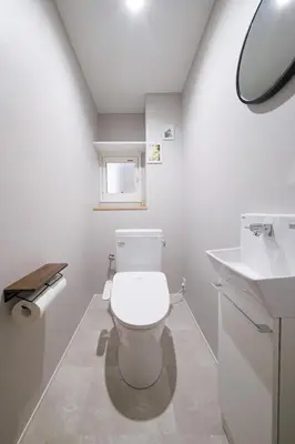 a bathroom with a toilet and a sink at Breeze Stay Shiohama in Tokyo