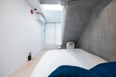 a bedroom with a white bed and a window at PASEO\u5e02\u8c37\u53f0\u753all in Tokyo