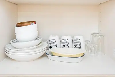 a pile of bowls and plates sitting on a shelf at Akihabara Skytree Premium Apartment 302 in Tokyo