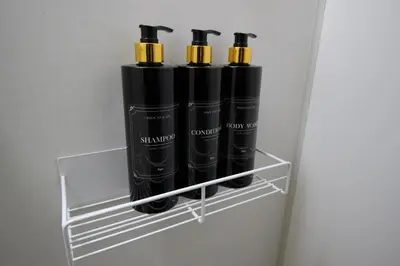 a shelf with four black batteries on it at Hotel Little Stay Tateishi 1F in Tokyo