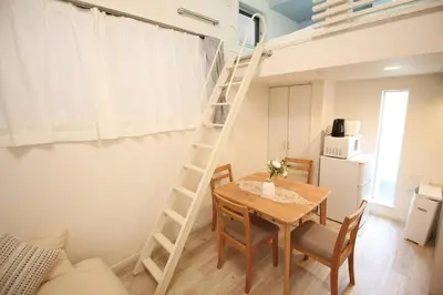 a room with a table and a loft bed at Hotel Little Stay Tateishi 1F in Tokyo