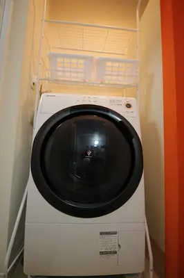 a washer and dryer sitting in a room at Hotel Little Stay Tateishi 1F in Tokyo