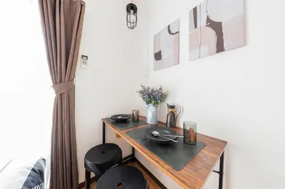 a small table in a room with two chairs at Shinjuku Homely Stay in Tokyo