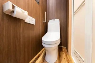 a bathroom with a white toilet in a room at Shinjuku Homely Stay in Tokyo